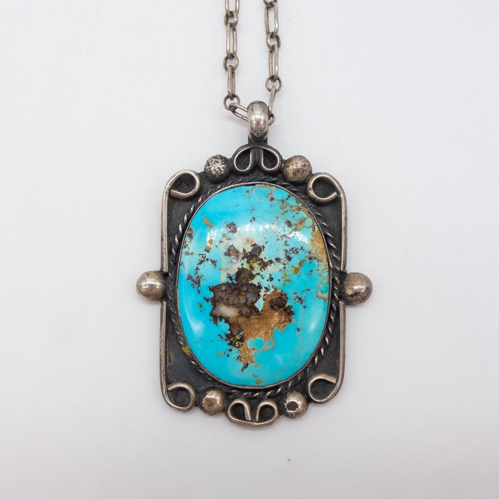 Navajo Sterling Silver Turquoise Necklace Signed TM: This is a vintage Native American pawn Navajo sterling silver pendant necklace with a large turquoise cabochon. Signed TM, which may indicate Terry Martinez as the artist. The pendant is 1 3/4 x 1 1/2