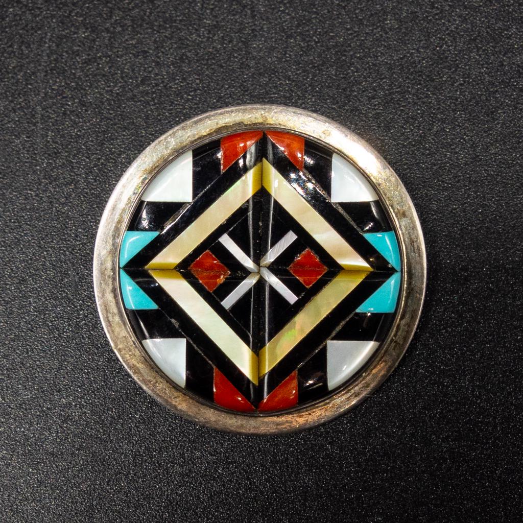 Zuni Sterling Silver Signed YK Natachu Inlay Pendant: This is a Native American sterling silver pendant/brooch crafted by Y.K. Natachu (Zuni). The pendant features an ornate inlay including turquoise, coral, mother of pearl, and onyx. Diameter: 1 1/8". W