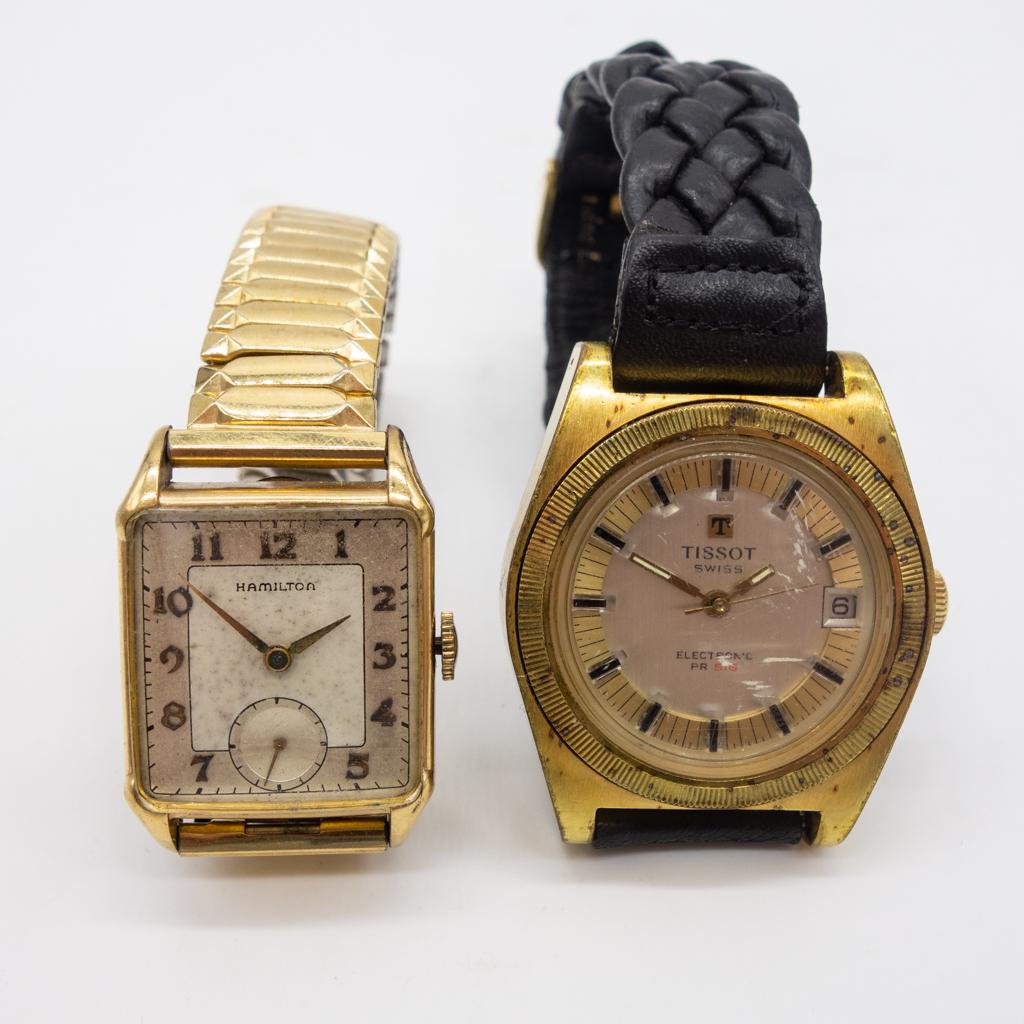 One Tissot and One Hamilton Wristwatch Gold Filled: This lot contains one Tissot wristwatch and one Hamilton wristwatch. The Tissot is an electronic PR 516 with a gold filled case and a braided black leather band. The Hamilton watch is rectangular manu