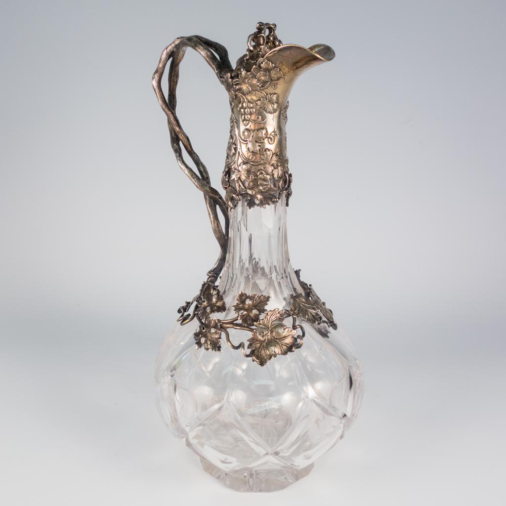 English Cut Glass Sterling Silver Mounted Wine Pitcher: This is an antique English cut glass sterling silver mounted wine pitcher dating to the Georgian era. The ornate grape vine and bunch motif sterling silver mountings are marked for Joseph Angell I & J