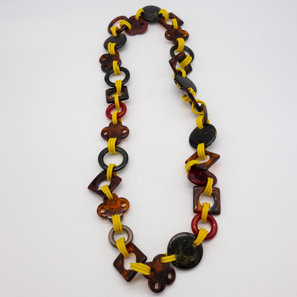 Vintage Bakelite Carved Panel Necklace 36": This is a vintage necklace with Bakelite carved panels. Plastic yellow links. 36" long. The total weight is 157.6g.