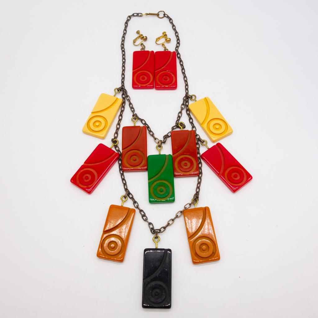 Vintage Carved Bakelite Panel Necklace Earrings Set: This is a vintage Bakelite carved colorful panel necklace and earrings suite. The necklace length is 22" at the longest loop. Each panel is 1 7/8 x 1". The total weight is 129.8g.