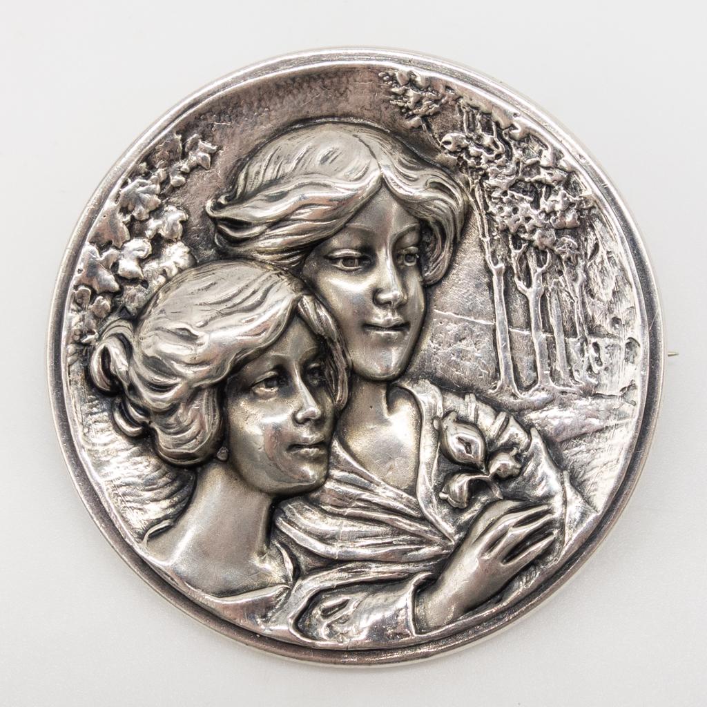 Art Nouveau William Link Silver Gibson Girls Pin: This is an antique brooch pin from William Link of Newark, New Jersey. Made in fine sterling silver, this Art Nouveau pin features a landscape scene with two women rendered in the Gibson Girl style. C