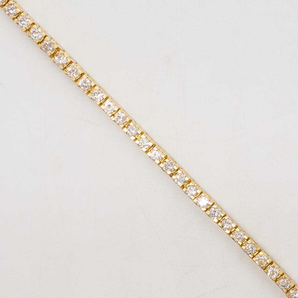 Vintage 14K Gold 3.5tcw+ Diamond Tennis Bracelet: This is a vintage ladies tennis bracelet rendered in fine 14K yellow gold. The bracelet features 50 round brilliant cut diamonds. The diamond clarity is SI-I and the color his HI. The bracelet length 