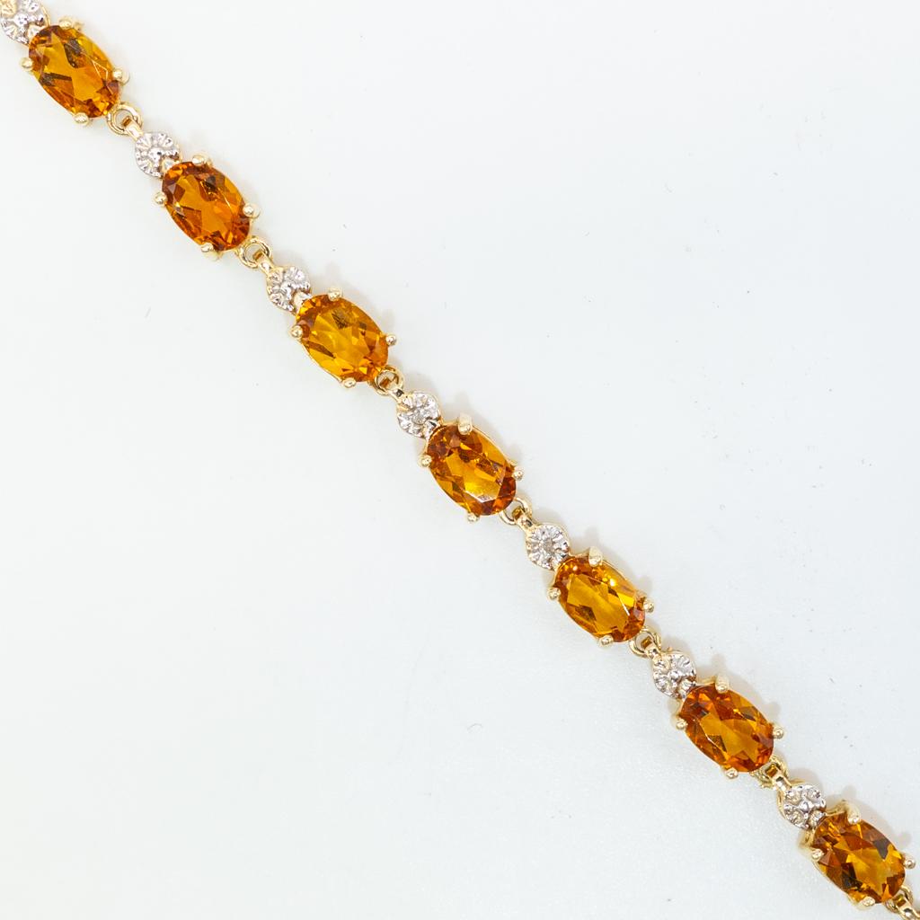 14K Gold 6.32cts Citrine Diamond Bracelet w AIG COA: This is a contemporary ladies bracelet rendered in fine 14K gold. It is studded with 6.32cts of citrine gemstons and 0.02cts round brilliant cut diamonds. The citrines are Type I, medium light, slight