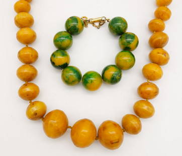 Vintage Mid Century Beaded Bakelite Bracelet and Necklace for Repair: This is a vintage lot of Mid Century beaded Bakelite jewelry including a marbled green and yellow bead bracelet and a carved butterscotch bead necklace. The bracelet is 7 3/4" long. The beads along