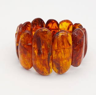 Vintage Natural Graduated Bead Baltic Amber Bracelet: This is a vintage graduated bead natural Baltic amber bracelet. Strung on elastic. the beads range in length from 1 1/2 to 2 1/8". It weighs a total of 60.8g