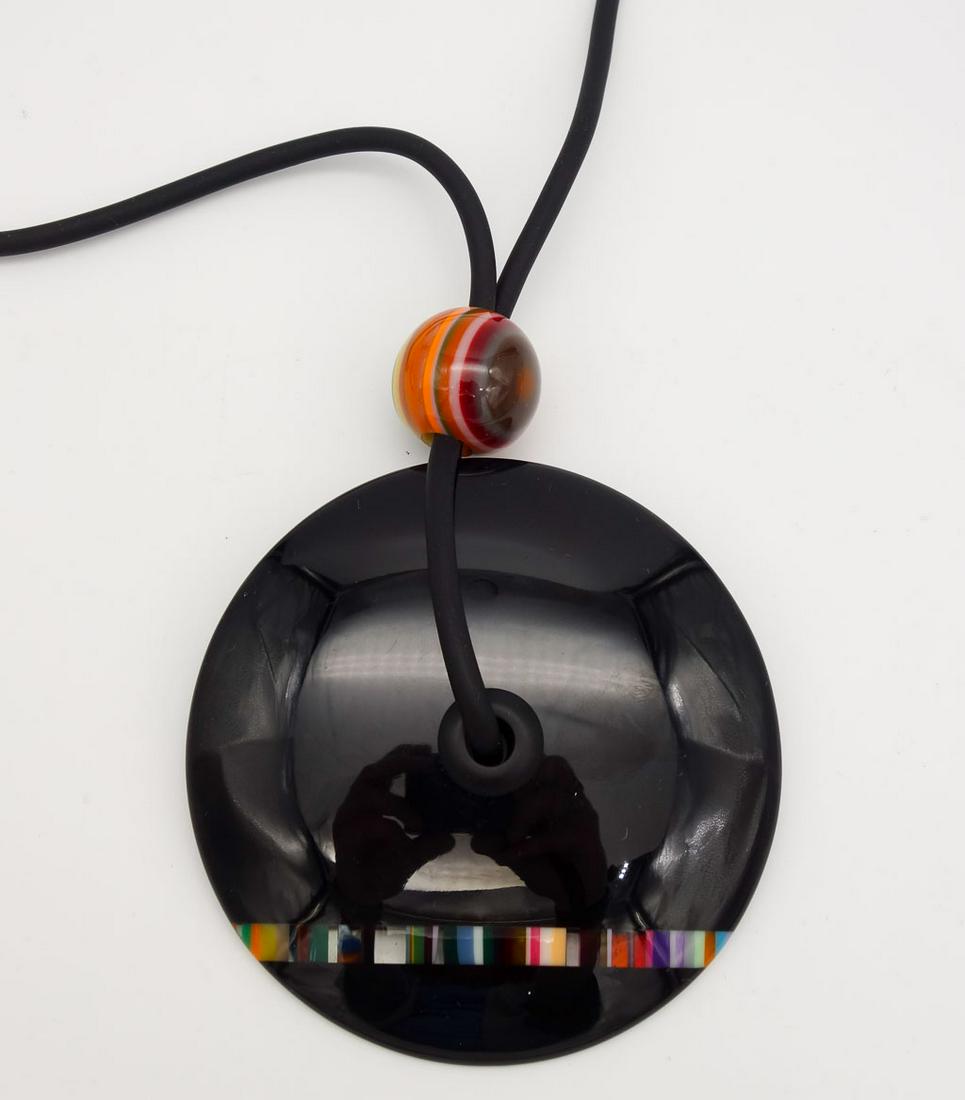 Sobral Pop Art Resin Colorful Stripe Lariat Style Pendant Necklace: This is a vintage resin necklace from Brazilian designer Carlos Sobral. The black disc lariat style necklace is accented with a colorful stripes. The necklace length is 36". The pendant is 3 1/2" diam
