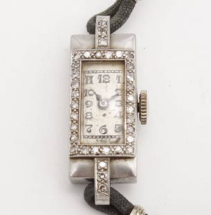 Antique Art Deco Platinum Diamond Ladies Swiss 17J Wristwatch: This is an antique Art Deco ladies wristwatch rendered in fine platinum and accented with single cut diamonds. The case is 22.8 x 10.5mm. It is 30mm from lug end to lug end. The total weight is 12g.