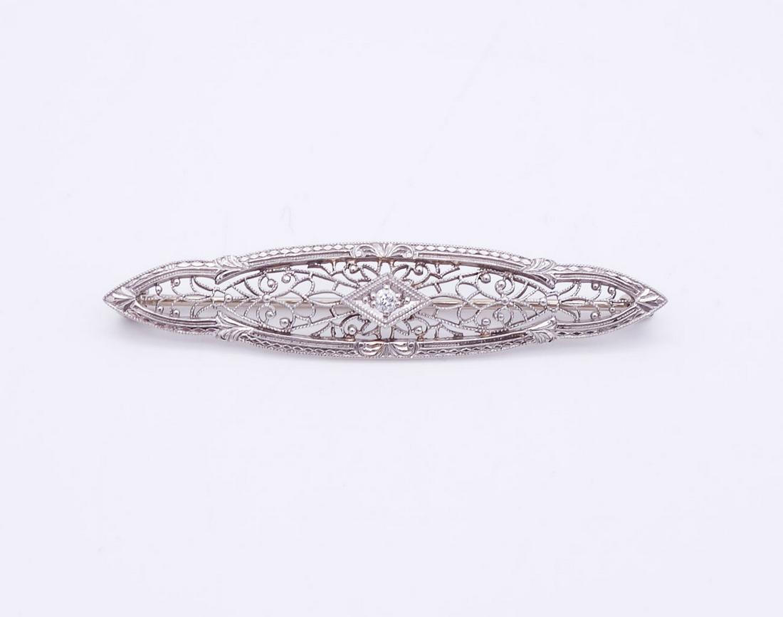 Antique 1920s Art Deco 14K White Gold Filigree Diamond Brooch Pin: This is an antique 14K white gold filigree brooch pin featuring an Old European cut diamond of VS clarity and GH color. 1 3/4" long and it weighs 2.5g. The diamond is 1.9mm.
