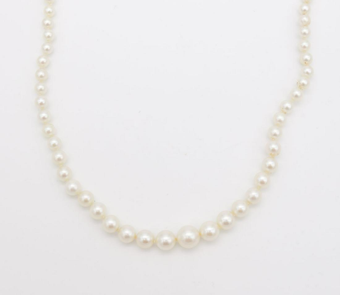 Antique 14K White Gold Diamond Art Deco Graduated Pearl Sweetheart Necklace: This is an antique graduated pearl single strand sweetheart necklace featuring a 14K white gold Art Deco filigree clasp with a single cut diamond. The necklace is 18" long and the pearls range from 3.