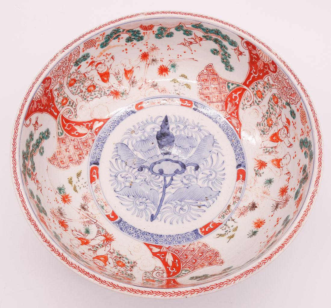 Asian Bowl Porcelain Bowl Figures and Cranes in Landscape: This is an antique Chinese bowl dating to the 19th if not as early as the 18th century (possibly Kangxi). The porcelain bowl features a central floral design with figures in landscape and cranes rende