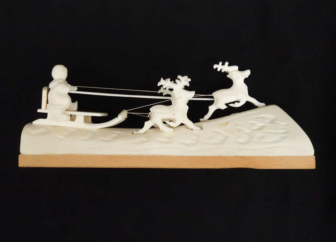 Vintage Scandinavian Carved Bone Reindeer Sled Figurine: This is a vintage Scandinavian hand carved bone model of three reindeer pulling a figure in a sled. Mounted on a wooden base. 7 1/4" Long