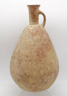 Ancient Amlash Incised Rounded Pottery Vessel w Lug Handle: This is an ancient Near East Amlash rounded body pottery vessel with a cylindrical neck and flared rim. It is decorated with three incised rings below the lug handle. The underside is decorated with