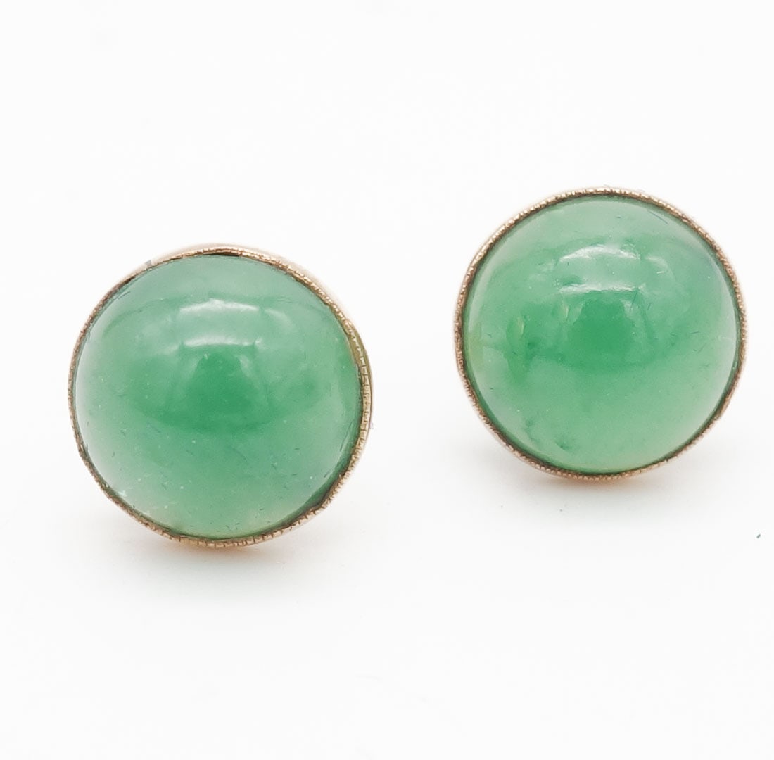 Vintage 14K Gold Green Jadeite Cabochon Stud Earrings: This is a vintage pair of 14K gold stud earrings each featuring a green jadeite cabochon. Each earring face is 10.9mm. The total weight is 3.4g. Each cabochon is about 10.5mm.