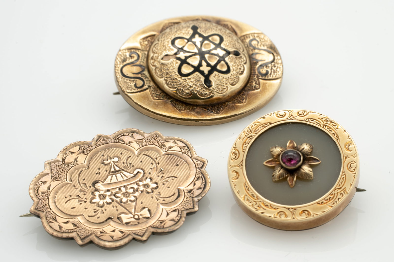 Group of 3, Ornate American 19 c. Gold GF Brooches including Enamel Onyx: Lot 69 Group of 3, Ornate American 19 c. Gold GF Brooches including Enamel Onyx Largest: 1.23 x .97 x .44 in. Smallest: .82 x .45 in. 16.8 g