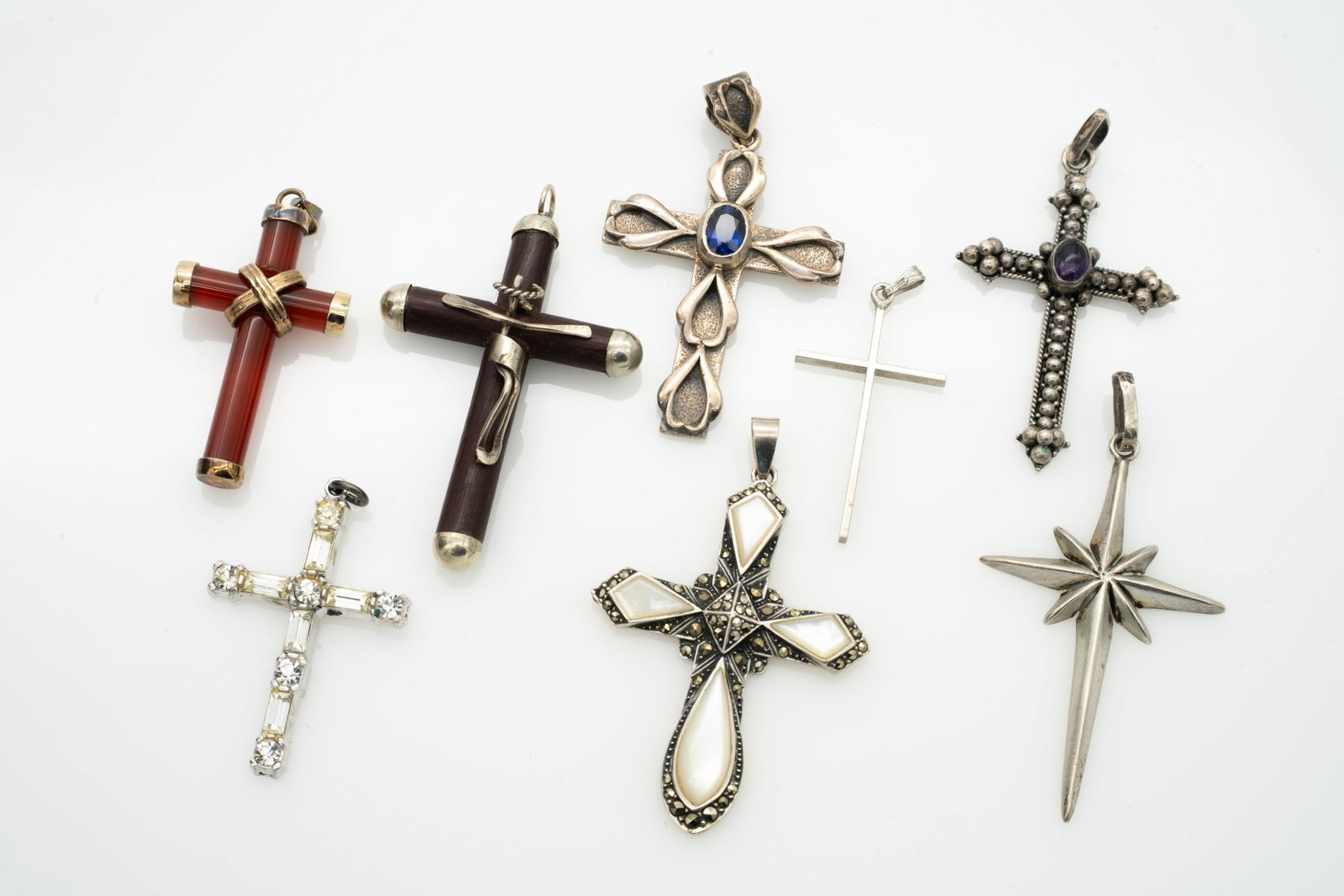 Lot of 8 Cross Pendants incl Sterling Silver and Hardstone: Lot 197 Lot of 8 Cross Pendants incl Sterling Silver and Hardstone Largest (wood): 2.07 x 1.3 x .45 in. Smallest (minimal): 1.37 x .73 x .08 in. 35.1 g