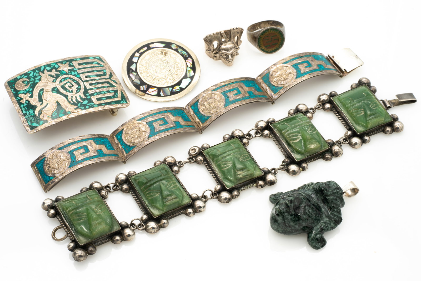 Group of 7 Vintage Jewelry Pieces with Mayan Inspired Design incl Carved Jadeite Pendant: Lot 218 Group of 7 Vintage Jewelry Pieces with Mayan Inspired Design incl Carved Jadeite Pendant Belt Buckle: 1.63 x 2.18 x .48 in. Pendant (excluding Bail): 1.64 x 1.48 x .8 in. Fcae Ring Size: 8.5,