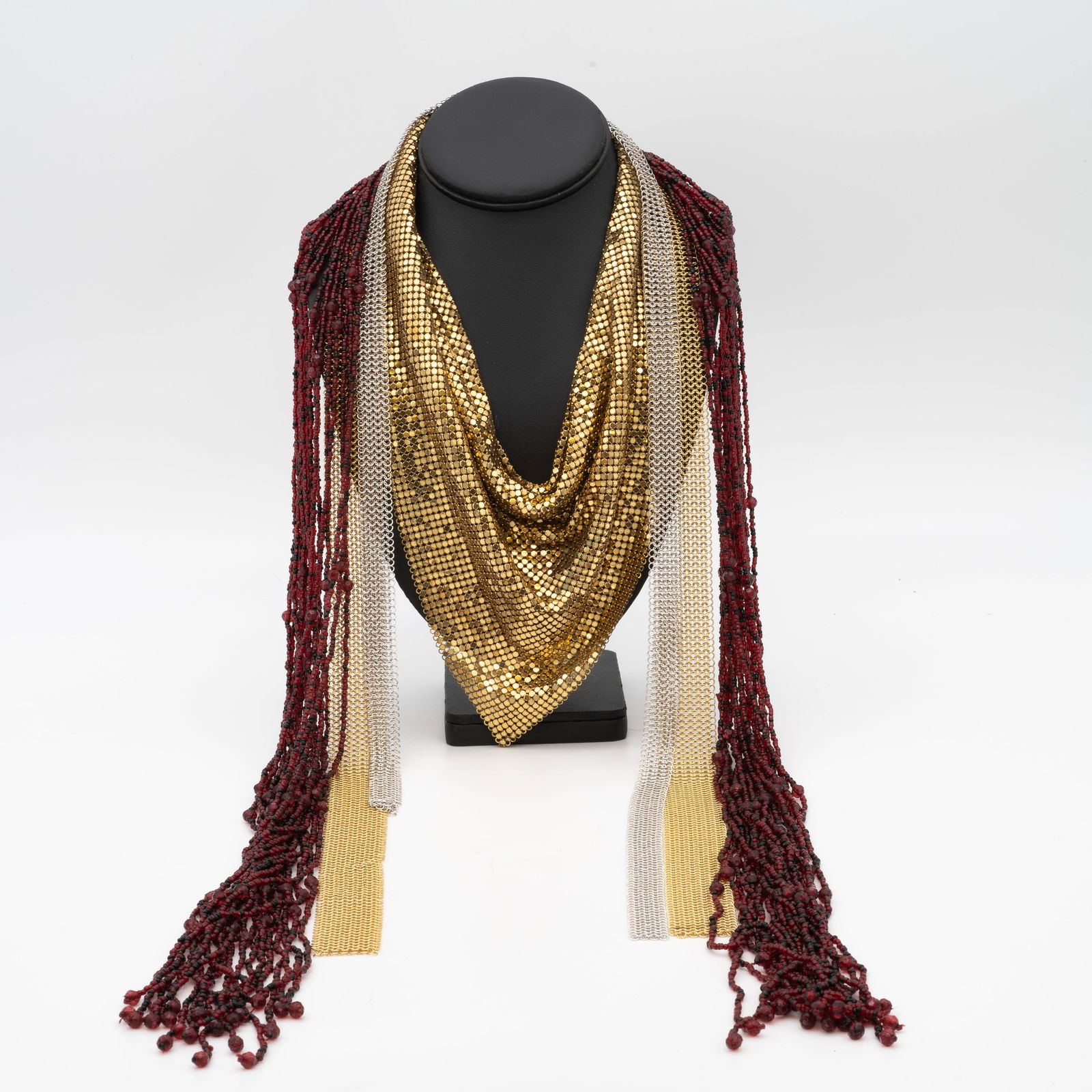 3 Vintage Mid-Century Mesh and Torsade Necklaces: Lot 100 3 Vintage Mid-Century Mesh and Torsade Necklaces Description: Triangular Necklace Stamped: MESH / WHITING [ampersand] Davis Co / BAGS Dimensions: Red Beaded Length: 53.5 in. Chainmail Length: