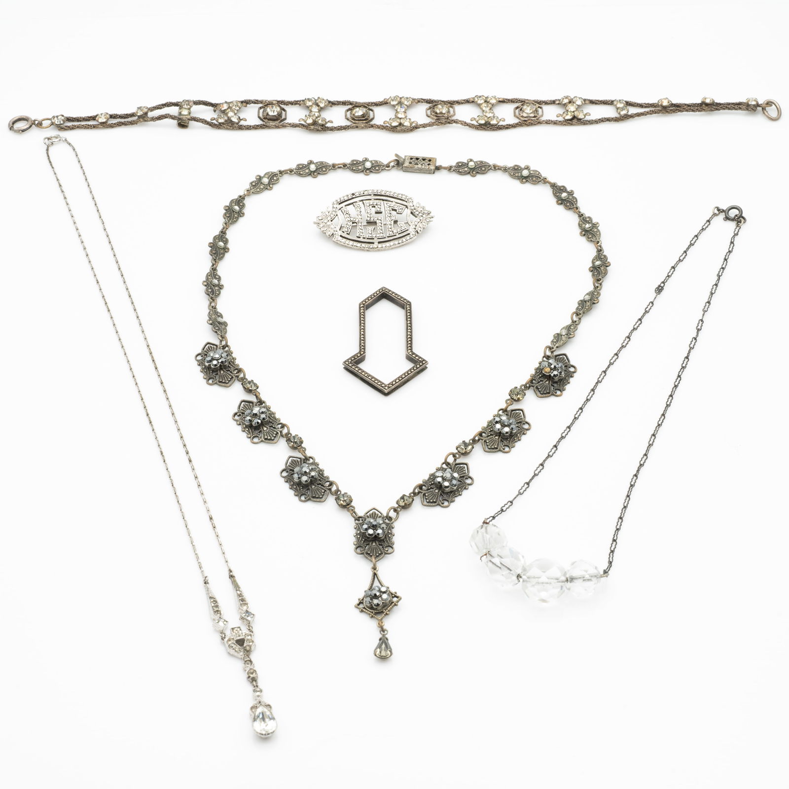 Vintage Antique Rhinestone Filigree Necklaces and Brooches, Marcasite, Sterling Silver incl French: Lot 106 Vintage Antique Rhinestone Filigree Necklaces and Brooches, Marcasite, Sterling Silver incl French Art Deco Description: Longest: 17.5 in. HSE Pendant: .88 x 1.51 x .22 in. Dimensions: Brooch