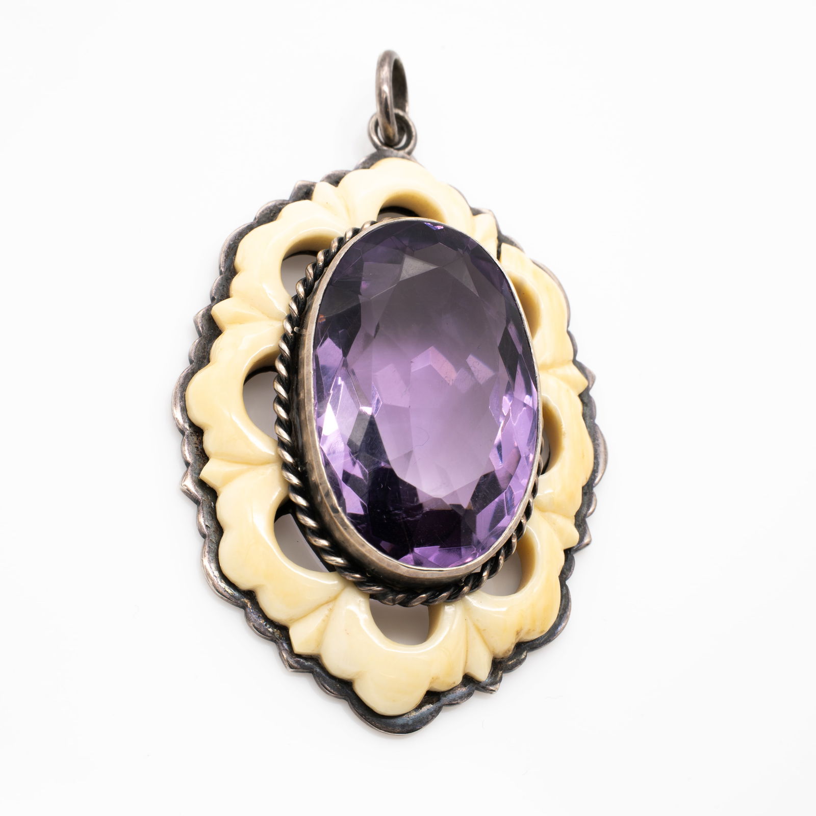 Antique Large German Handarbeit 900 Silver Amethyst Pendant Trimmed in Bone: Lot 154 Antique Large German Handarbeit 900 Silver Amethyst Pendant Trimmed in Bone Description: Stamped Verso: HANDARBEIT / 900 Material: Bone, Amethyst, 900 Silver Dimensions: Excludi