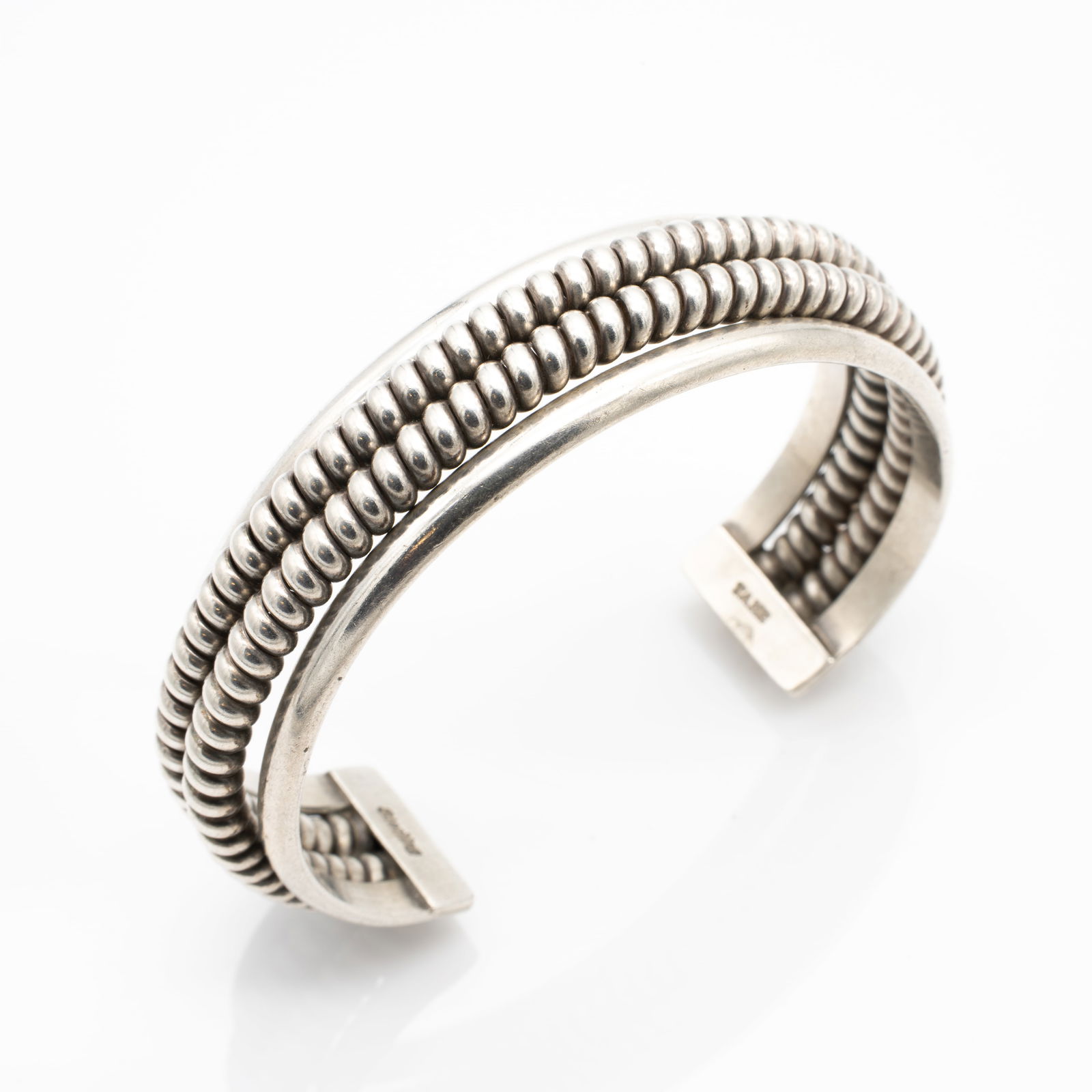 Nora Tahe, Navajo, Sterling Silver Native American Cuff: Lot 165 Nora Tahe, Navajo, Sterling Silver Native American Cuff Description: Stamped on Inside of Cuff: Sterling / TAHE Material: Sterling Silver Dimensions: Internal Circumference Incl