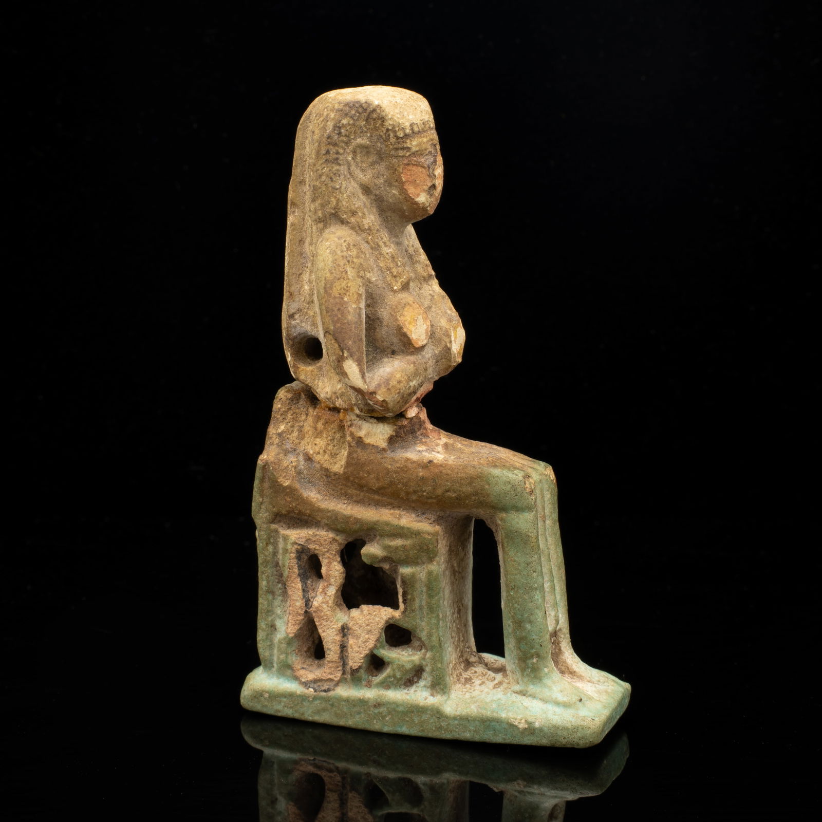 Faience Glazed Egyption Seated Isis Figure incl Hieroglyphs: Lot 227 Faience Glazed Egyption Seated Isis Figure incl Hieroglyphs Description: A small Egyptian faience figurine, likely depicting a seated Isis breastfeeding and wearing what appears to be a nemes