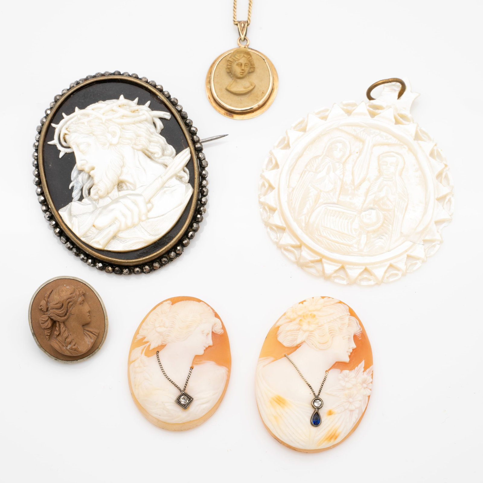Lot of Antique Carved Cameos, Diamond, Sapphire, Signed Mother of Pearl, Lava, 10k Gold Frame,: Lot 313 Lot of Antique Carved Cameos, Diamond, Sapphire, Signed Mother of Pearl, Lava, 10k Gold Frame, Gold-Filled Chain Description: Diamonds Single Cut si/ij. Sapphire. One of the small pendants inc