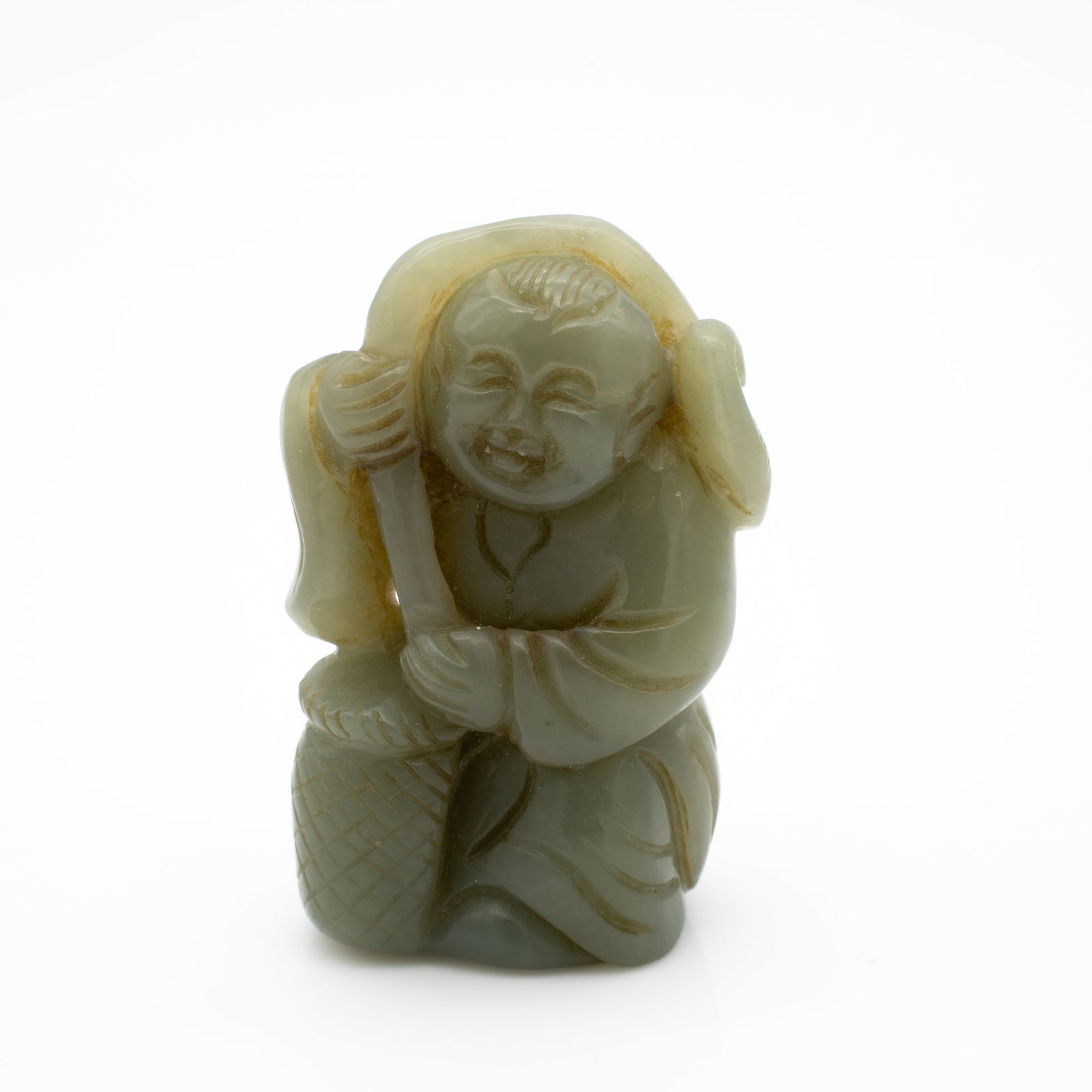 Carved Chinese Jade Figure of a Smiling Figure with Lingzhi Fungus and Basket: Lot 5 Carved Chinese Jade Figure of a Smiling Figure with Lingzhi Fungus and Basket Description: Rendered in pale celadon jade with soft translucency and a waxy luster, this carving depicts a smiling