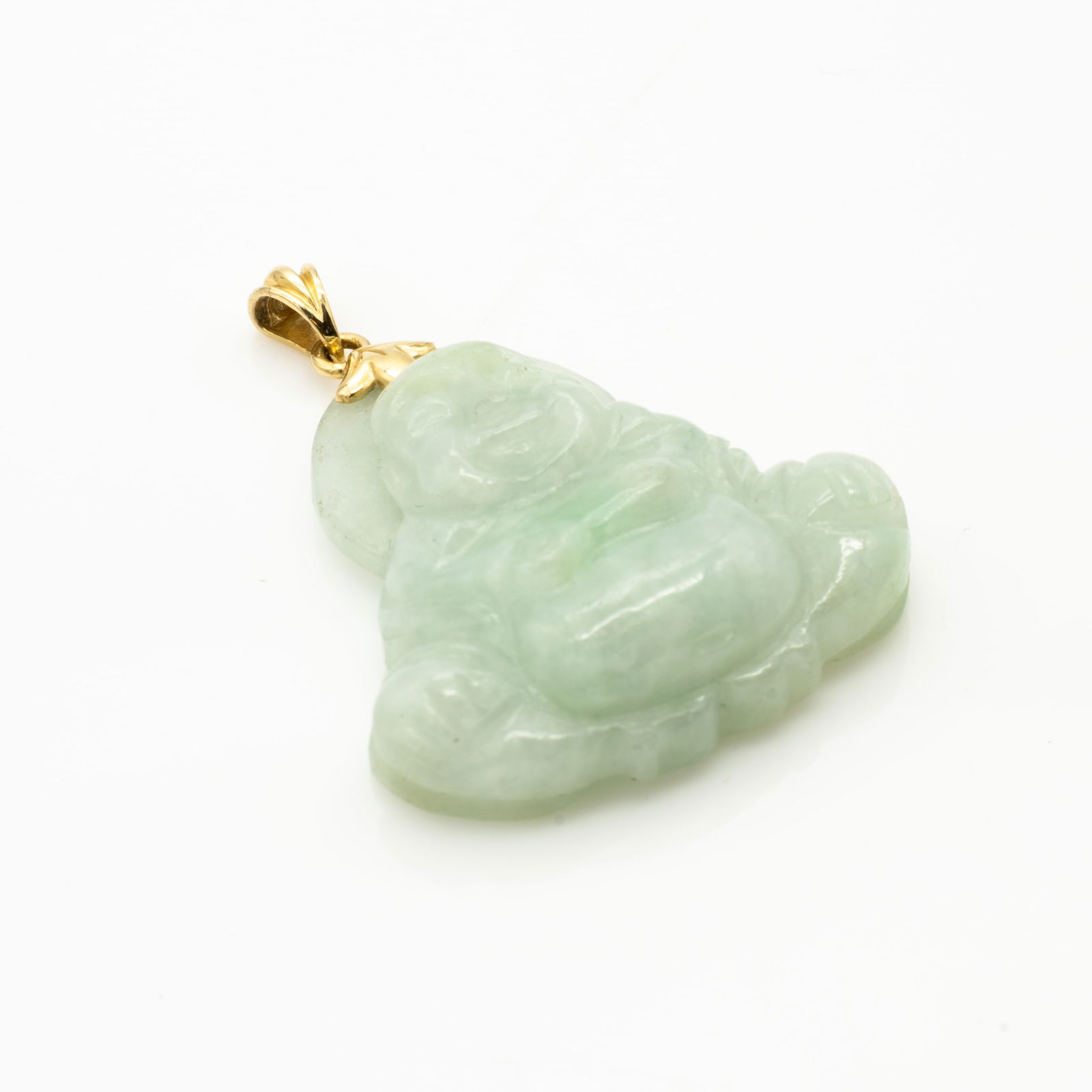 14K Gold and Carved Jadeite Laughing Buddha Pendant: Lot 119 14K Gold and Carved Jadeite Laughing Buddha Pendant Description: A light green jadeite pendant carved in the form of a seated laughing Buddha, set with a 14k yellow gold bail. Identifying Mark