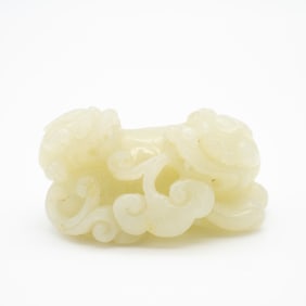 A Carved Chinese Pale Celadon Jade Toggle Depicting Two Fu Lions on Clouds