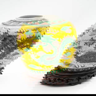 Chinese Famille Jaune Dragon Vase with Stand: Lot 153 Chinese Famille Jaune Dragon Vase with Stand Description: A porcelain jar featuring a hand-painted green dragon amid swirling clouds and flames on a rich yellow background. Provenance: From a