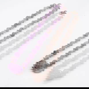 Pair of Carved Chinese Amethyst and Rose Quartz Bead Necklaces: Lot 179 Pair of Carved Chinese Amethyst and Rose Quartz Bead Necklaces Description: A pair of bead necklaces crafted from semi-precious hardstones: The first necklace features spherical beads carved f