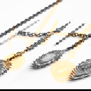Two Antique Gold GF Victorian Watch Chains with Fobs Incl Compass Fob: Lot 218 Two Antique Gold GF Victorian Watch Chains with Fobs Incl Compass Fob Description: Two antique gold-filled Victorian-era watch chains, each with T-bar attachments and decorative fobs. One chai