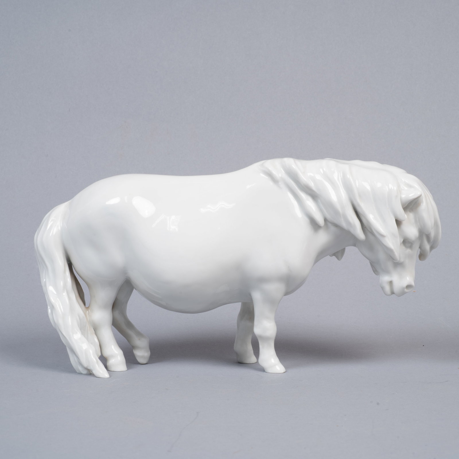 Meissen Standing Shetland Pony Porcelain Figure: Lot 268 Meissen Standing Shetland Pony Porcelain Figure Description: A modeled and glazed porcelain figure of a stout pony or small draft horse, produced by Meissen. Rendered in a high-gloss white gla