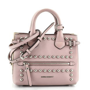 Burberry Banner Tote Studded Leather Baby: Burberry Banner Tote Studded Leather Baby Exterior Color: Pink Interior Color: Black Exterior Material: Leather Interior Material: Fabric Hardware Color: Silver Accessories: Dust