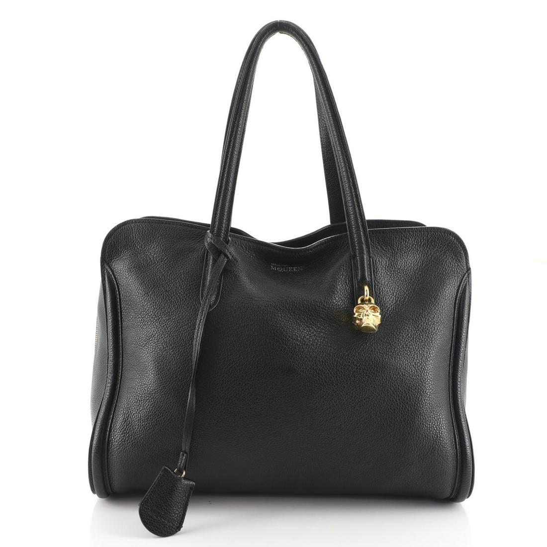 Alexander McQueen Padlock Zip Around Tote Leather Medium: Alexander McQueen Padlock Zip Around Tote Leather Medium Exterior Color: Black Interior Color: Brown Exterior Material: Leather Interior Material: Fabric Hardware Color: Gold Accessories: Clochett