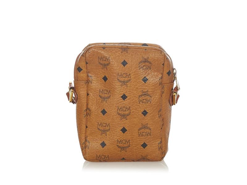 MCM Visetos Leather Crossbody Bag: MCM Visetos Leather Crossbody Bag This crossbody bag features a leather body, a flat leather strap, an exterior front zip pocket, and a top zip closure.Sku: 1JMCSH035Category: Crossbody BagType of mat