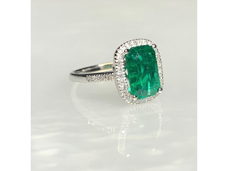 14K White Gold Emerald Cut Emerald Diamond Ring: 14K White Gold Emerald Cut Emerald Diamond Ring Product Code: 14KWHITEGO-62017B617ABA0 Condition: Never Worn A graceful and timeless emerald ring featuring a vibrant deep green emerald cut center ston
