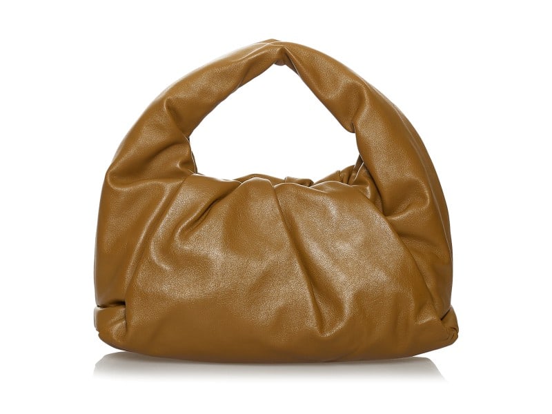Bottega Veneta The Shoulder Pouch Bag: Bottega Veneta The Shoulder Pouch Bag Product Code: GAILKQUYNT5E25XK Brand: Bottega Veneta Condition: Pre-Owned The Shoulder Pouch bag features a leather body, a flat strap, and a top magnetic frame c