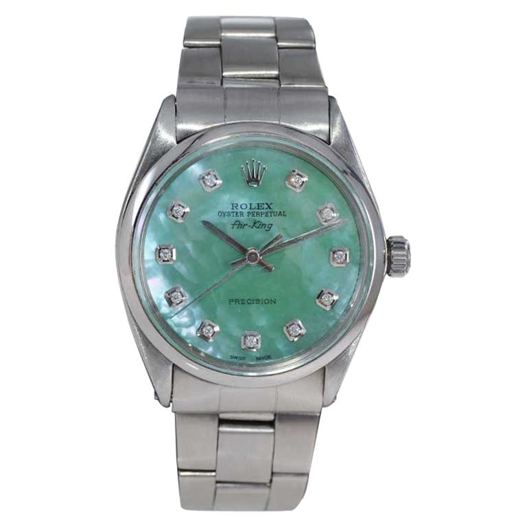 Rolex Stainless Steel Air King: Rolex Stainless Steel Air King with Custom Mother of Pearl Diamond Dial, 1970s Brand: Rolex Case Material: Stainless Steel Stone: Diamond Stone Cut: Round Cut Case Diions: Diameter: 1.34 in (34 mm)