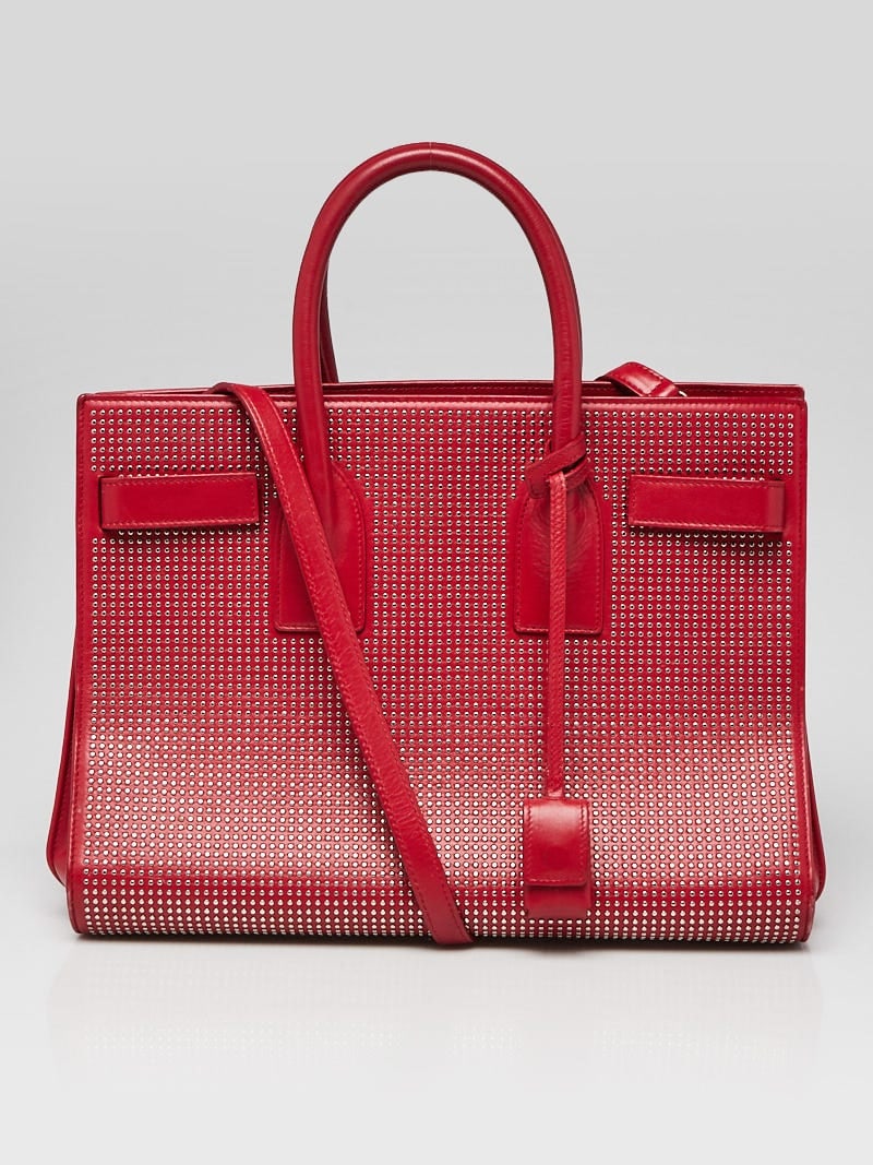 Yves Saint Laurent Red Leather: Yves Saint Laurent Red Leather Studded Small Sac de Jour Tote Bag Overall Condition: Gently used Exterior Condition: Gently used Interior Condition: Gently used Designer: Yves Saint Laurent Material: 