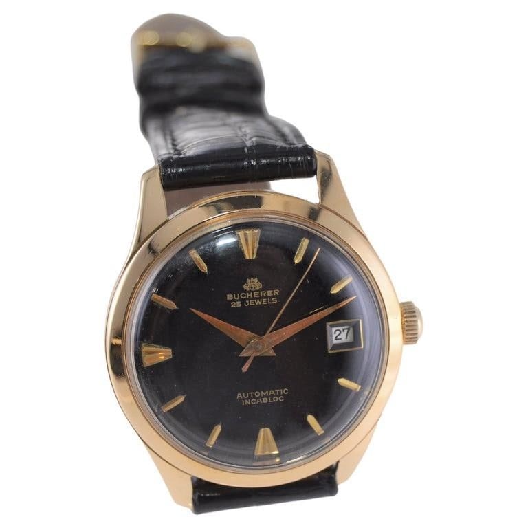 Bucherer Automatic 18Kt Gold Art: Bucherer Automatic 18Kt Gold Art Deco Wrist Watch with Original Black Dial Brand: Bucherer Case Material: 18k Gold Case Shape: Round Movement: Manual Wind Place of Origin: Switzerland Period: 1950