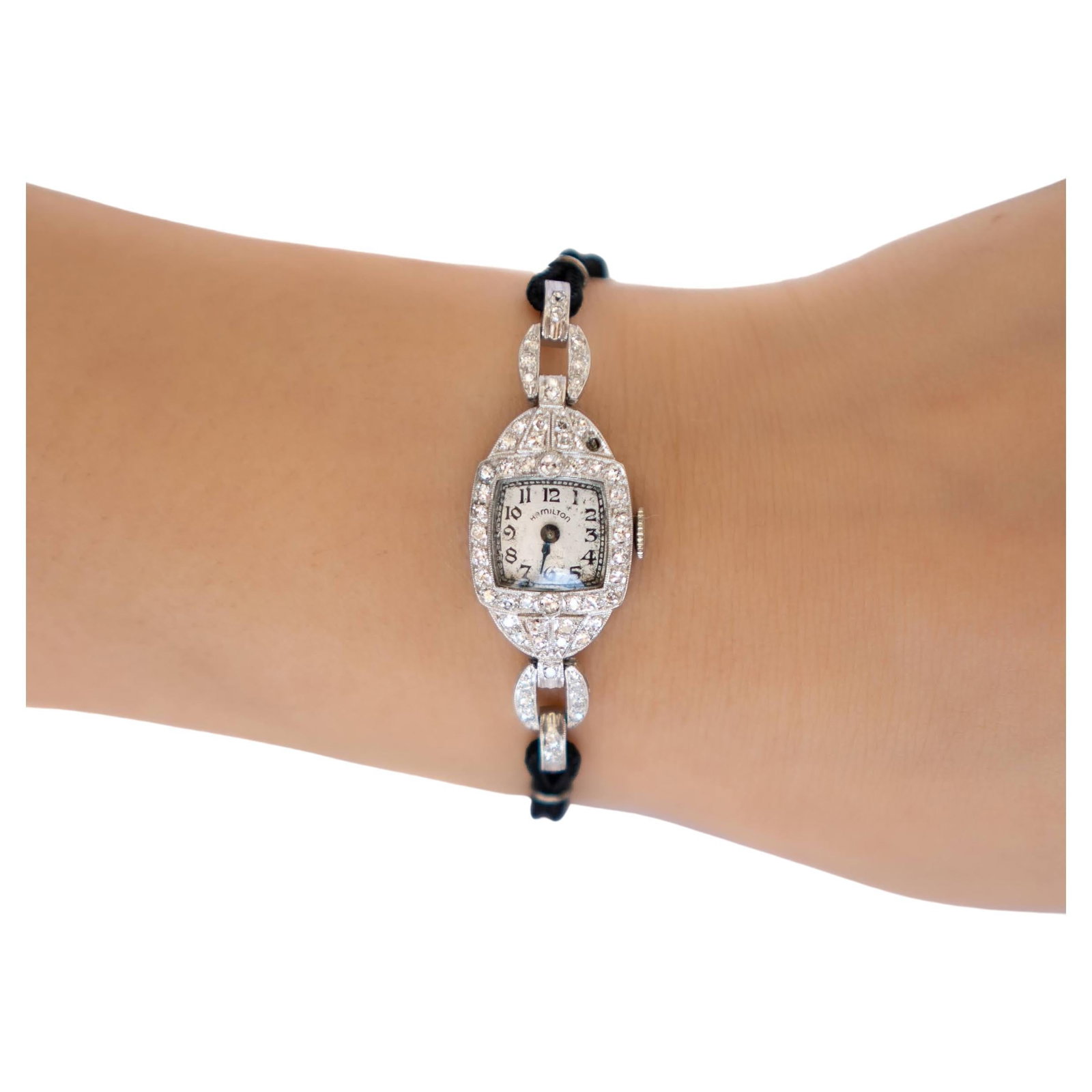 Vintage Ladys Platinum Hamilton Wristwatch: Vintage Ladys Platinum Hamilton Wristwatch Brand: Hamilton Case Material: 14k Gold, Platinum Stone: Diamond Stone Cut: Round Cut Weight: 13.1 g Strap Material: Fabric Case Shape: RoundOva