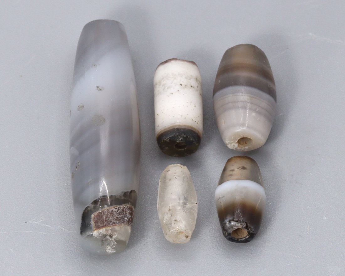 Antique Oriental Asian Handcrafted dZi Beads Collections: Antique Oriental Asian Handcrafted dZi Beads. Approx. 7/16 inch (smaller), 1 11/32 inch (bigger). Signs of wear and age, refer to photos. The lot is sold in the condition it is in at the time of sale.