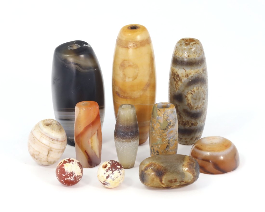 Group of Chinese Tibetan Carved Agate DZI Beads Collections: Group of Chinese Tibetan Carved Agate DZI Beads Collections. Approx. 5/16 inch (smaller), 1 17/32 inches (bigger). Signs of wear and age, refer to photos. The lot is sold in the condition it is in at