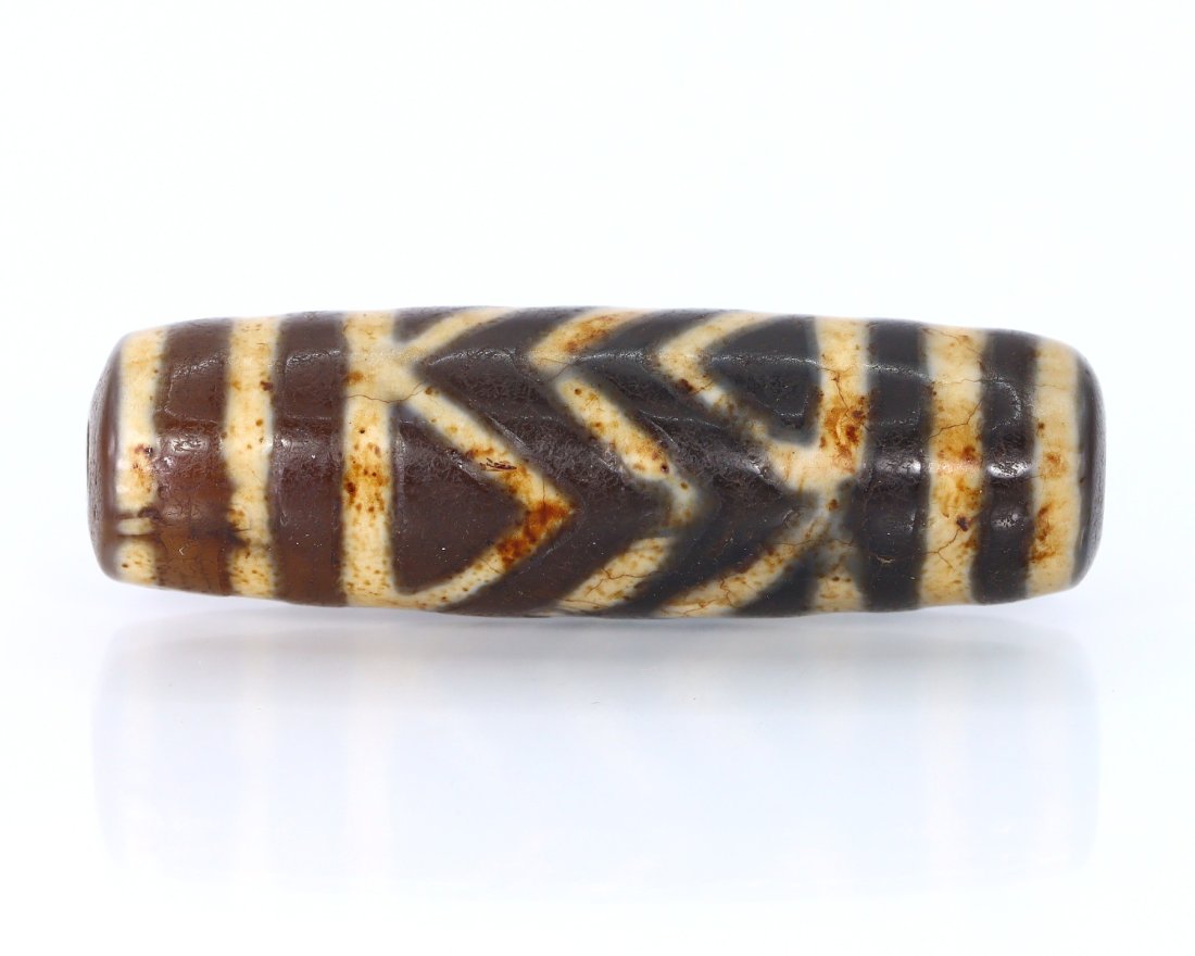 A New Tibetan dZi Bead Himalayan Asian Art Collection: Dimension: 1 47/64 inches New - Produced within the last 20 years Vintage - Over 20 years of age but less than 100 years of age Antique - Over 100 years of age but less than 500 years of age Ancient -