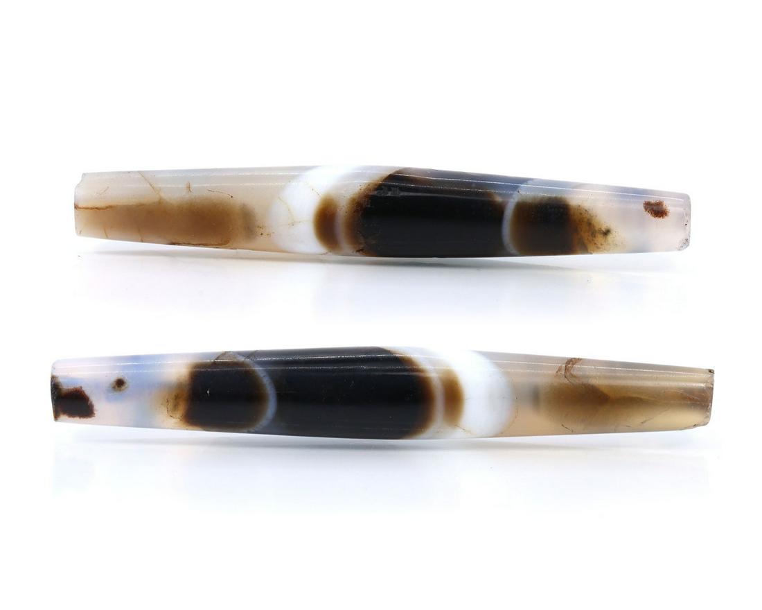 Two Antique Tibetan Pyu Banded Agate Chung dZi Beads Asian Art Carving Antique: Dimension: 64x9mm Thousand Planet Auction House Season 2 Asian Treasure Hunt Auction, auction including Abstract Oil Painting, Sculptures & Carvings, Statues & Statuettes, Bust Carving, Signet Rings,