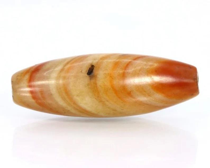 63.64Ct Himalayan Tibetan Natural Banded Agate Chung dZi Bead: Dimension: 43x15mm Natural History of Australian Opal & Mineral Auction by Thousand Planet Auction House featuring the beauty of Boulder Opal art in cabochon cutting and rough, well known Australian L