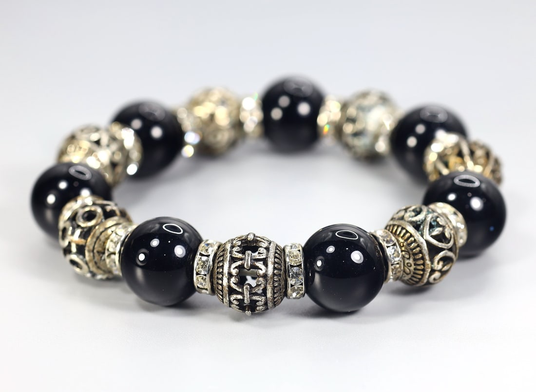 Collection of Black Glass Beads & Silver Charm Bracelet: 8" Inches Weight: 70 grams (Before Packing) A bargain hunter's, fixer-upper's, and pack-rat's dream come true! Our Ten2Go "warehouse" style auction presents over thousand lots in a fast-paced old-styl